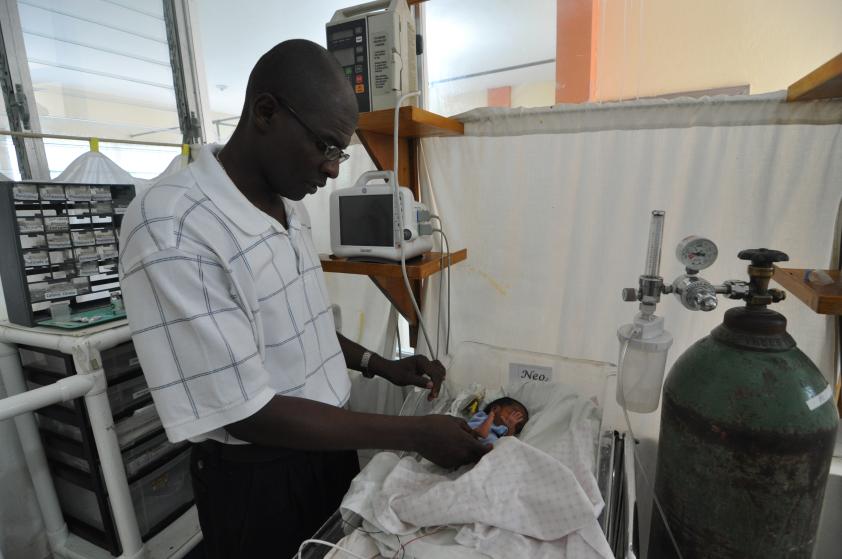 Dr. Pierre with baby in the NICU