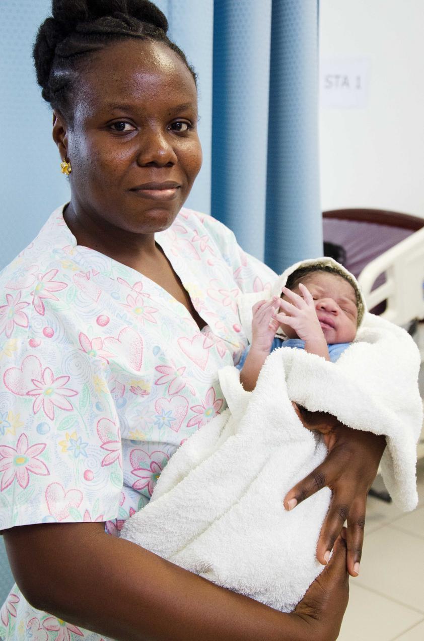 Ms. Toussaint holding newborn baby