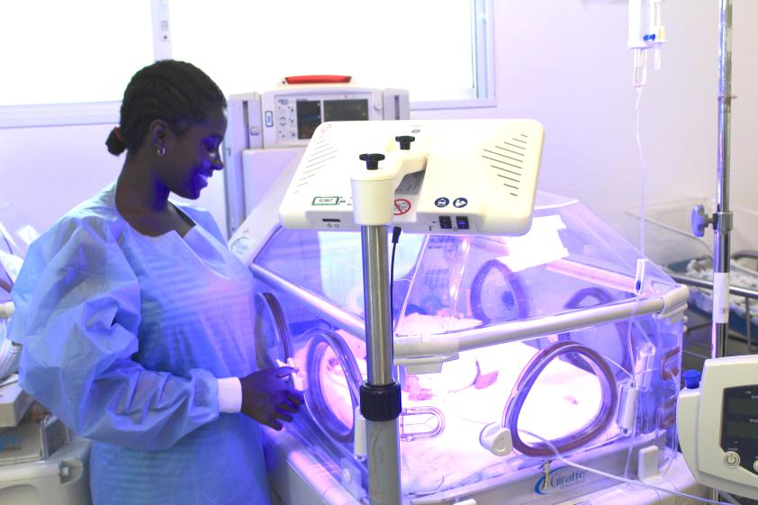Jessica Cadet looks at her baby in the incubator