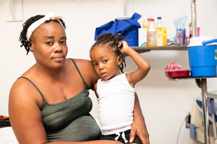 A Haitian woman sits with her son in St. Boniface Hospital's pediatric department.