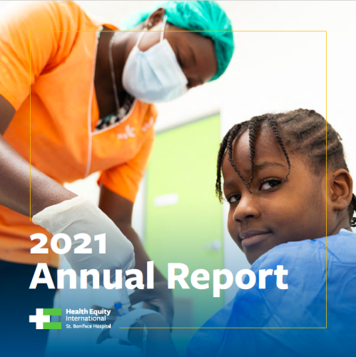A young Haitian girl looks to the side at the camera and smiles while a nurse in a while medical mass, orange scrubs, and turquoise hair covering tends to her hand. The words "2021 Annual Report" are written on the bottom of the image
