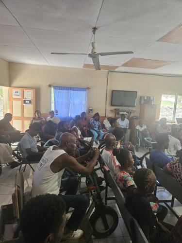 SCI beneficiaries, family members, and hospital staff attend a training about maternal health for women with spinal cord injuries.