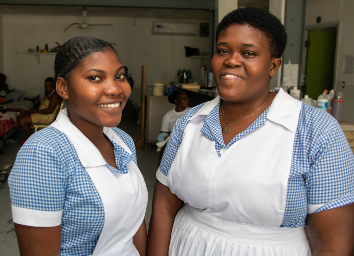 Two nursing interns in their white and blue uniforms in St. Boniface Hospital's pediatrics department.