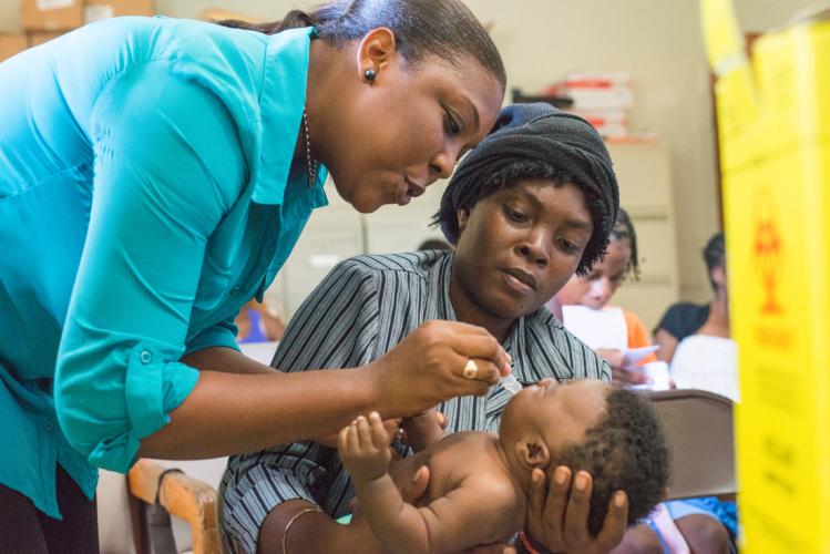 Nurse yanick giving baby immunization