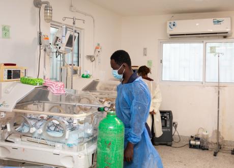 Angelo peeks into the neonatal incubator where his newborn baby, Atso Ruth, is laying.