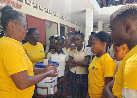Haitian community health workers review proper handwashing technique with schoolchildren in Les Cayes, Haiti.