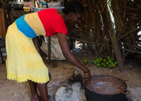 Mother stirring food in a large pot