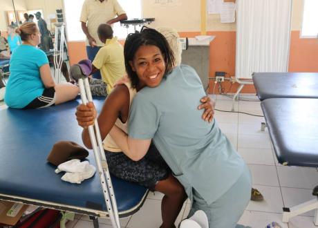 A patient at the prosthetic clinic hugs the OLUOL volunteer she was working with.