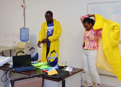Staff members at St. Boniface Hospital practice donning full-body personal protective equipment.