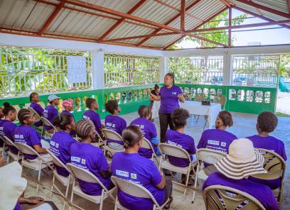 A Kore Sante employee speaks to a group of women for International Women's Day in 2024. 