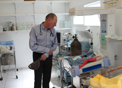 Dr. Paul Farmer looks in on a young patient in our neonatal intensive care unit.