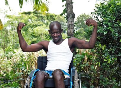 Man in wheelchair flexing his muscles