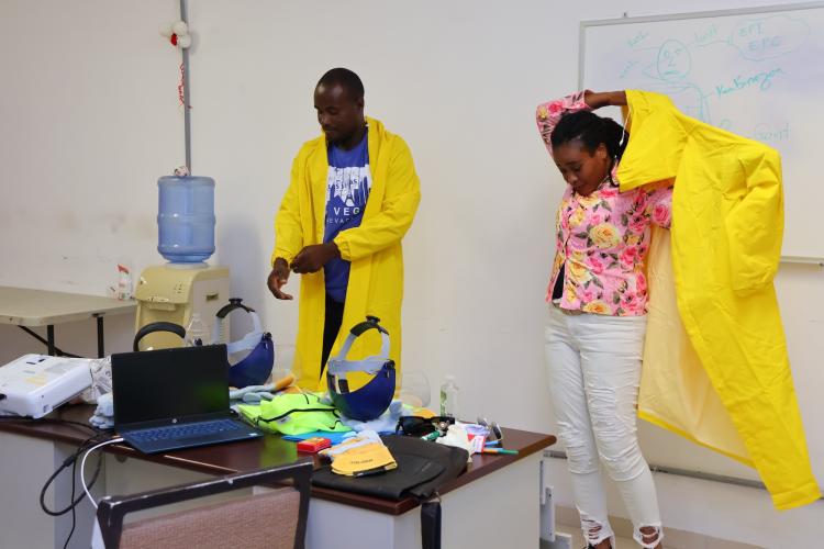 Staff members at St. Boniface Hospital practice donning full-body personal protective equipment.