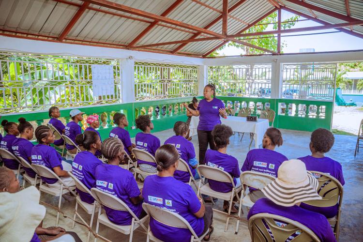 A Kore Sante employee speaks to a group of women for International Women's Day in 2024. 