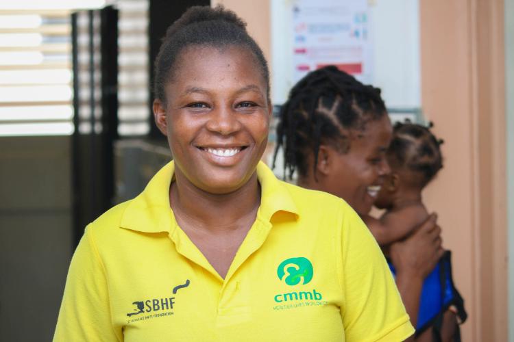 Miss Ginette Elipha, a Haitian community health worker, smiles.