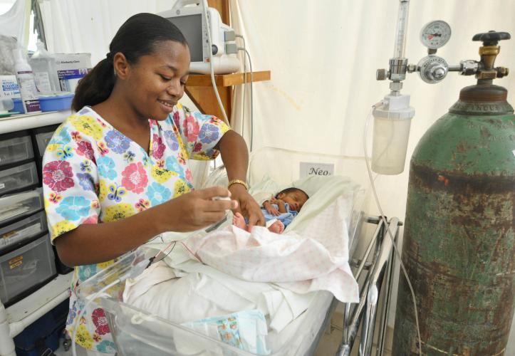 Nurse checking on baby in NICU