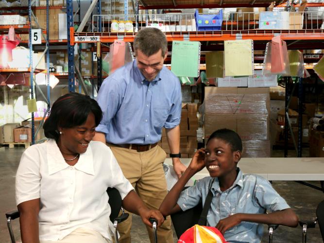 Renelson with his mother and SBHF President/CEO Conor Shapiro at an event honoring the Kellogg Foundation's contributions in Fond des Blancs