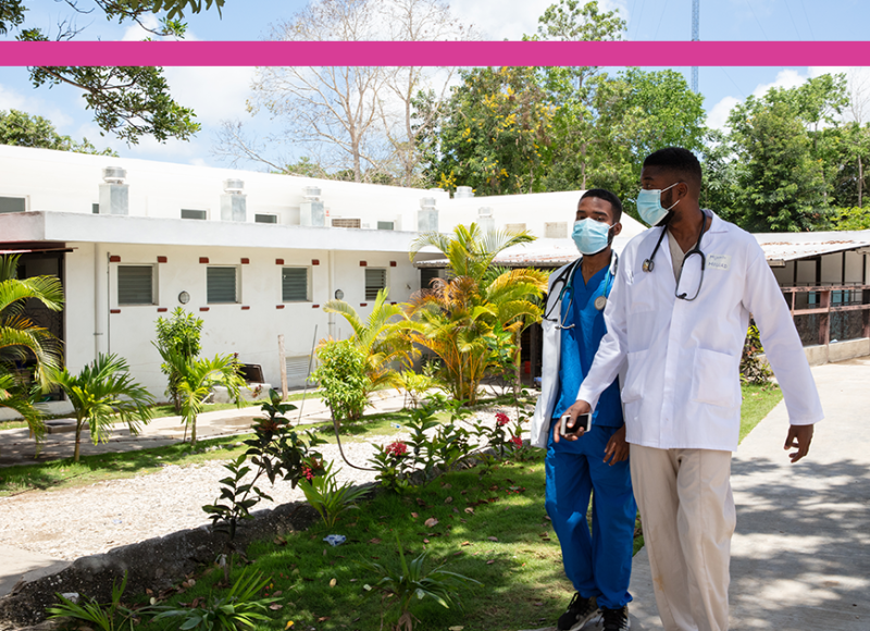 Two Haitian doctors walk alongside SBH's Center for Infectious Disease and Emergency Care