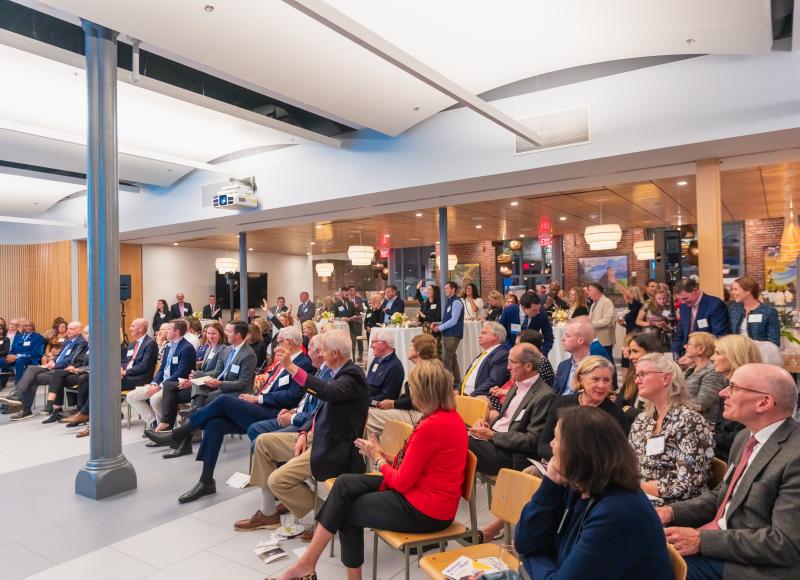 Guests at HEI's 2025 Celebration raise their hands during the event's Fund-a-Need.