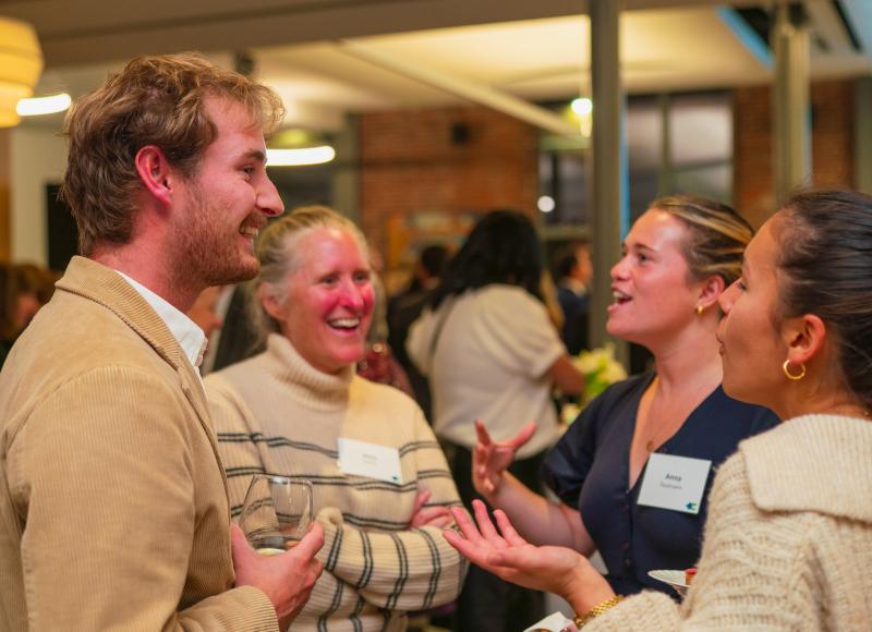 Guests at HEI's 2025 Celebration chat and connect during the event.