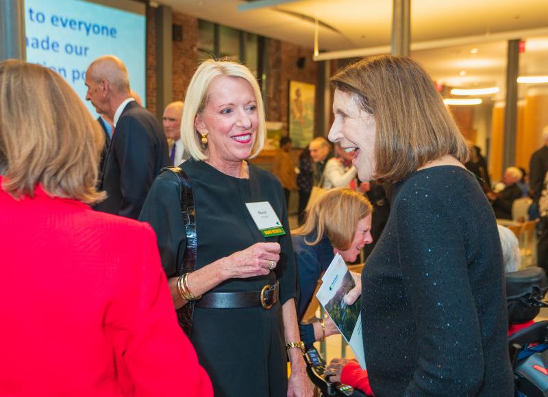 HEI Board Member Sharon McNally and Board Member Emerita Barrie Landry talk at HEI's 2025 Celebration