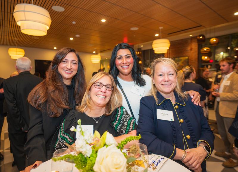 HEI event committee member Michele Brennan poses with friends and guests at HEI's 2025 Celebration.