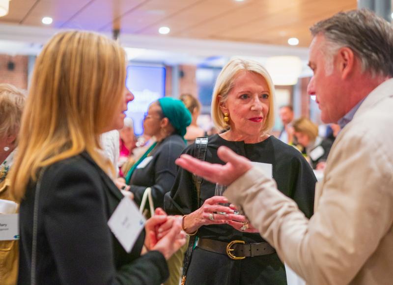 HEI Celebration 2025 honoree Sharon McNally converses with friends.