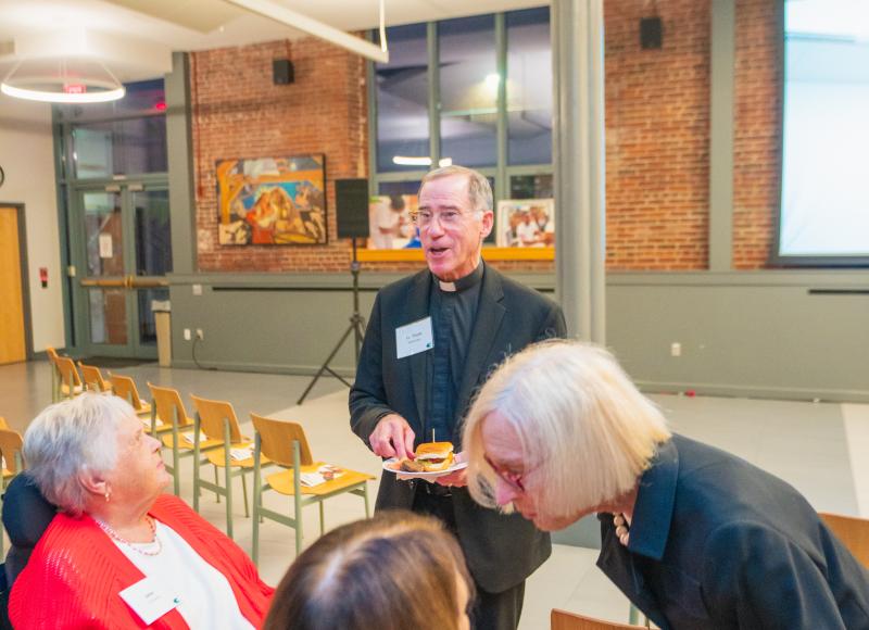 HEI Board Member Beth Floor talks with guests at the organization's 2025 Celebration