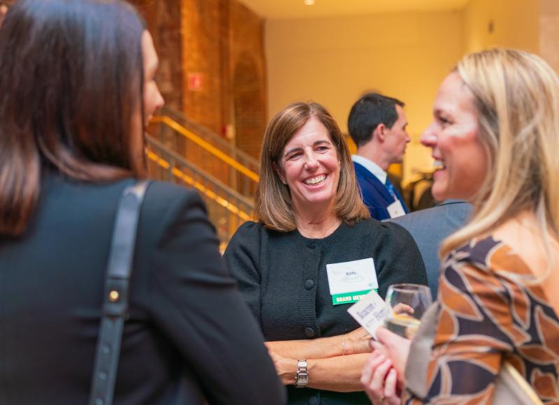 Board Member and Event Committee Member Kate Ascione talks with guests at HEI's 2025 celebration.