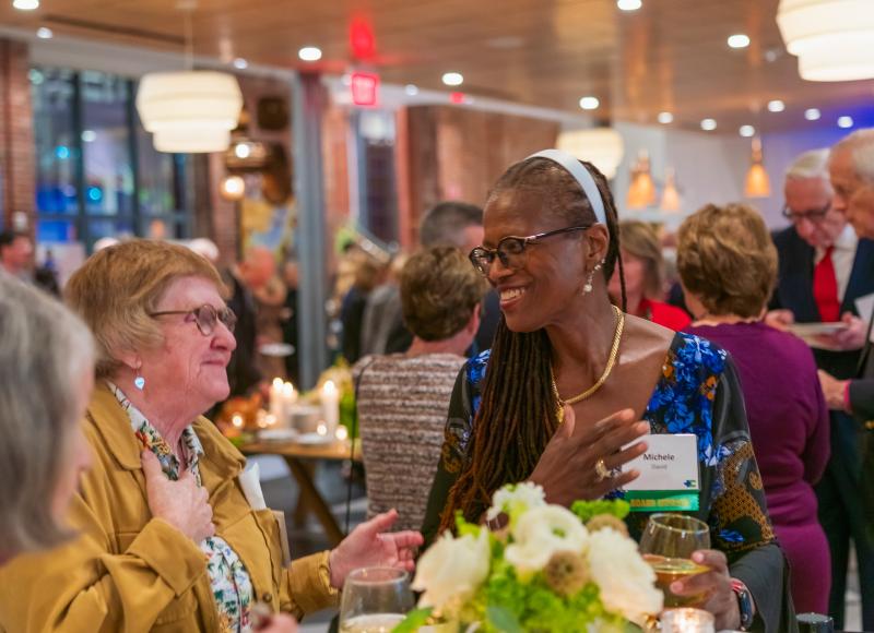 HEI Board Chair Michele David converses with a guest at the organization's 2025 Celebration.