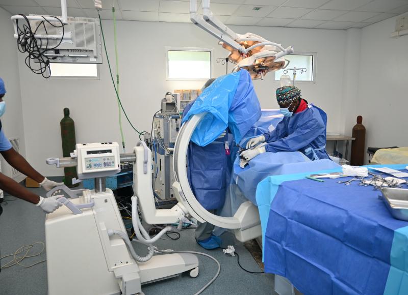 The SBH surgical team conducts a procedure using a C-arm imaging device.