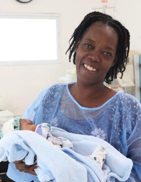 A Haitian mother holds her baby boy in St. Boniface Hospital's NICU.