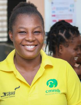 Miss Ginette Elipha, a Haitian community health worker, smiles.
