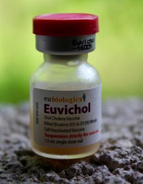 A close-up of a small vial of Euvichol oral cholera vaccine.