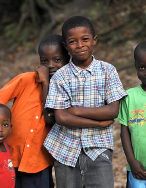 Group of four young children smiling