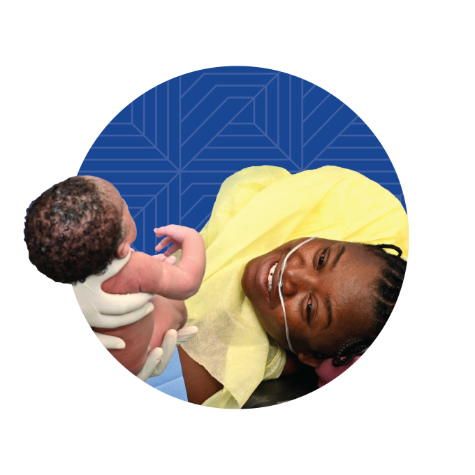 A Haitian woman looking at her newborn baby after a C-section superimposed over a dark blue circle with geometric designs on it.